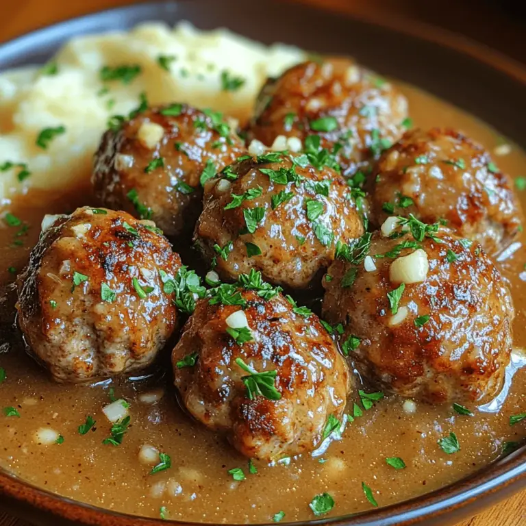 Savory Baked Turkey Meatballs with Garlic Gravy is a delightful dish that seamlessly combines comfort and health. These meatballs, tender and flavorful, offer a satisfying meal that appeals to both the palate and the well-being of those who enjoy them. Ground turkey serves as a lean protein source, making it an excellent choice for health-conscious eaters looking to reduce fat intake without sacrificing taste. The dish is further elevated by a rich garlic gravy that adds a layer of depth and flavor, transforming simple meatballs into a gourmet experience.